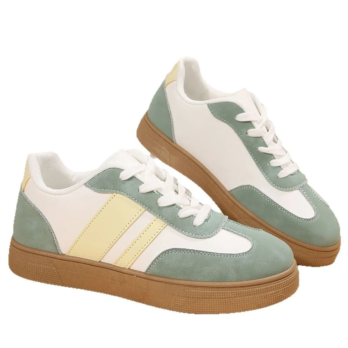 Green women's retro trainers with a cross strap design, round toe, and white rubber sole.