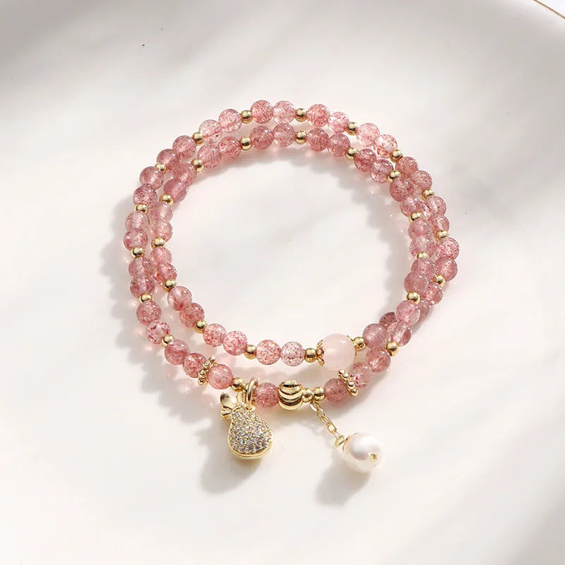 Women's strawberry quartz bracelet with geometric wallet-style design and adjustable beaded construction