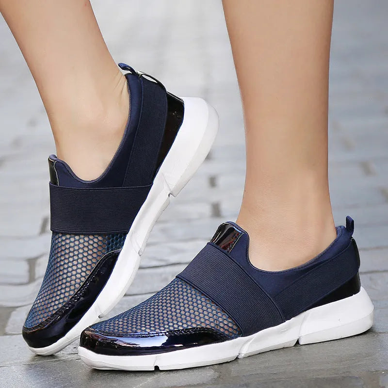 Blue, black, and grey women's low-top sneakers with a mesh lining and lightweight design.