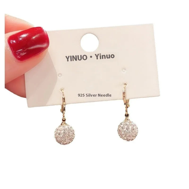 A pair of women's geometric copper earrings with a rose design and small zircon stone accents.
