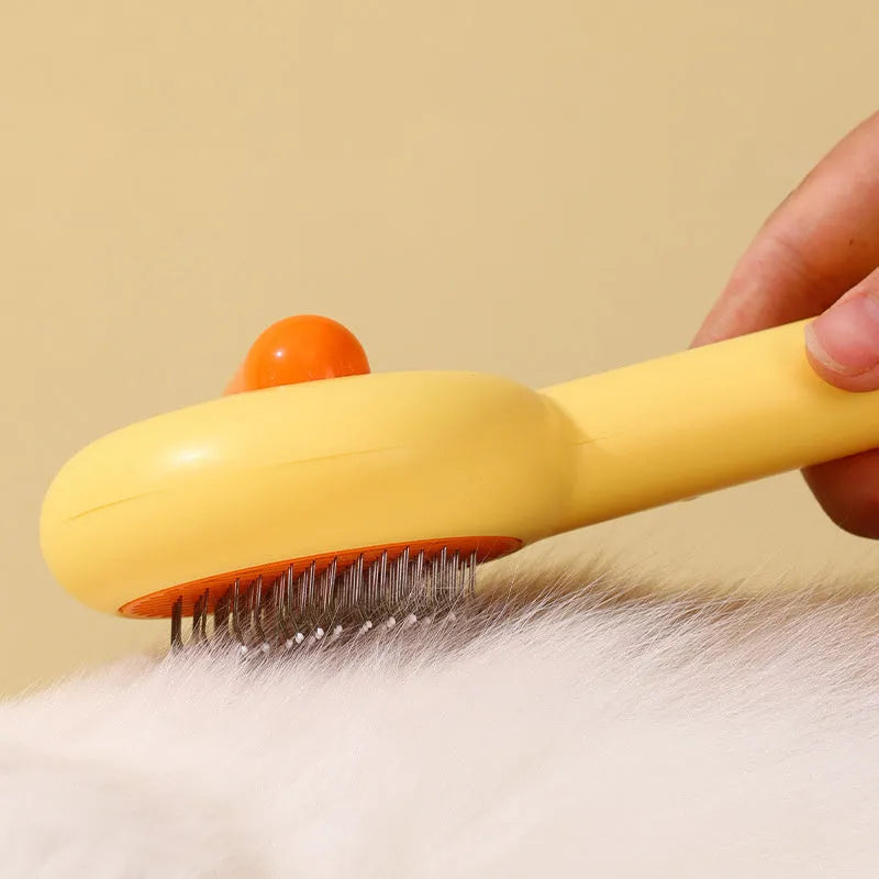 Small yellow duck-shaped pet comb with needle bristles for grooming cats and dogs