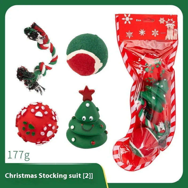Seven Christmas gift bags containing vinyl dog toys with Santa heads, trees and deer figures