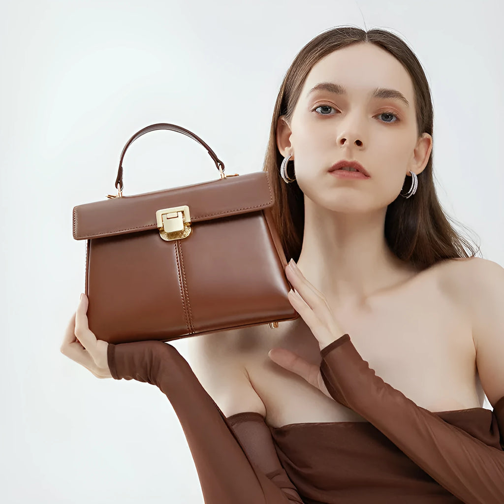 Women's genuine leather shoulder bag with vachette clasp in horizontal square design showing internal compartments
