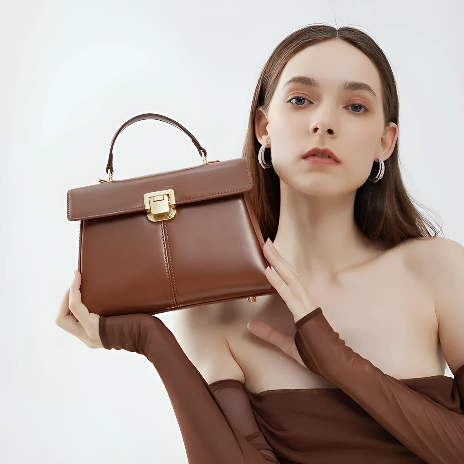 Women's genuine leather shoulder bag with vachette clasp in horizontal square design showing internal compartments