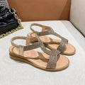 Gold women's patent leather sandals with rhinestone decoration and a non-slip sole.