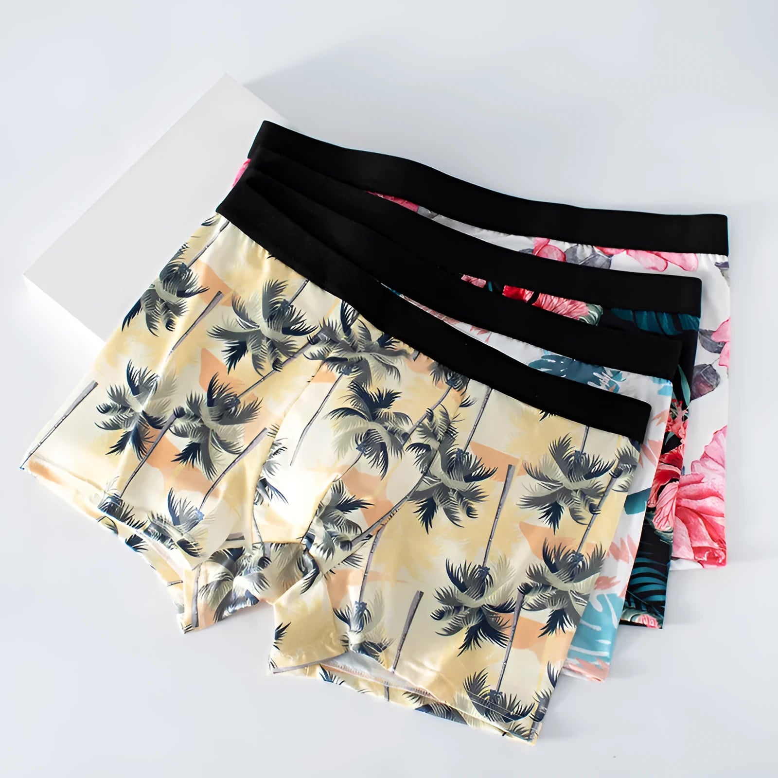 Ice silk men's underwear with fashion printing in polyester fabric, showing mid-waist design and breathable construction