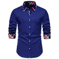 A man's blue plaid long sleeve shirt with a triangle collar on a hanger.