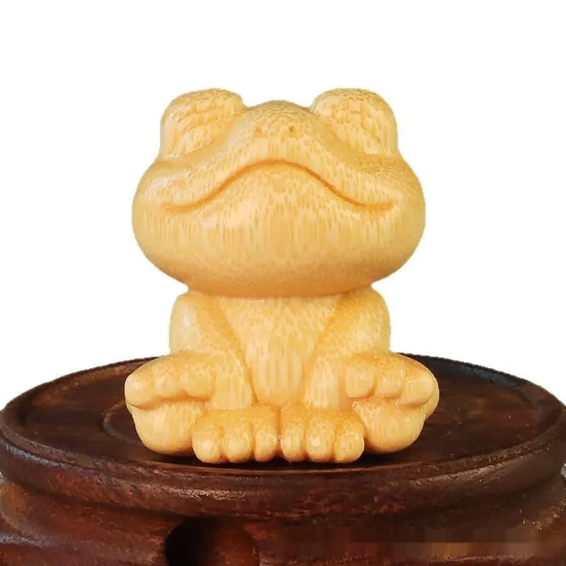 Solid bamboo carving ornament of smiling frog design measuring 5cm height and 4.5cm diameter