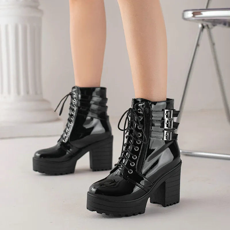 Women's black thick-heel ankle boots with round toe and front lace-up design.