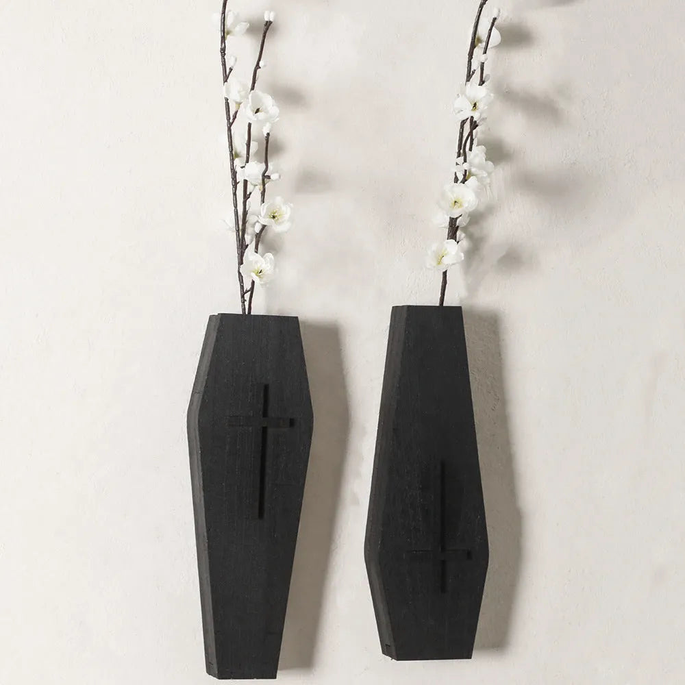 Black cross-shaped wooden wall shelf for home decoration, measuring 27 by 9 centimetres.
