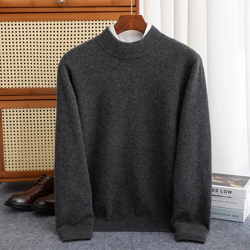 Man wearing a half-collar loose wool sweater in a textured rough yarn knit.