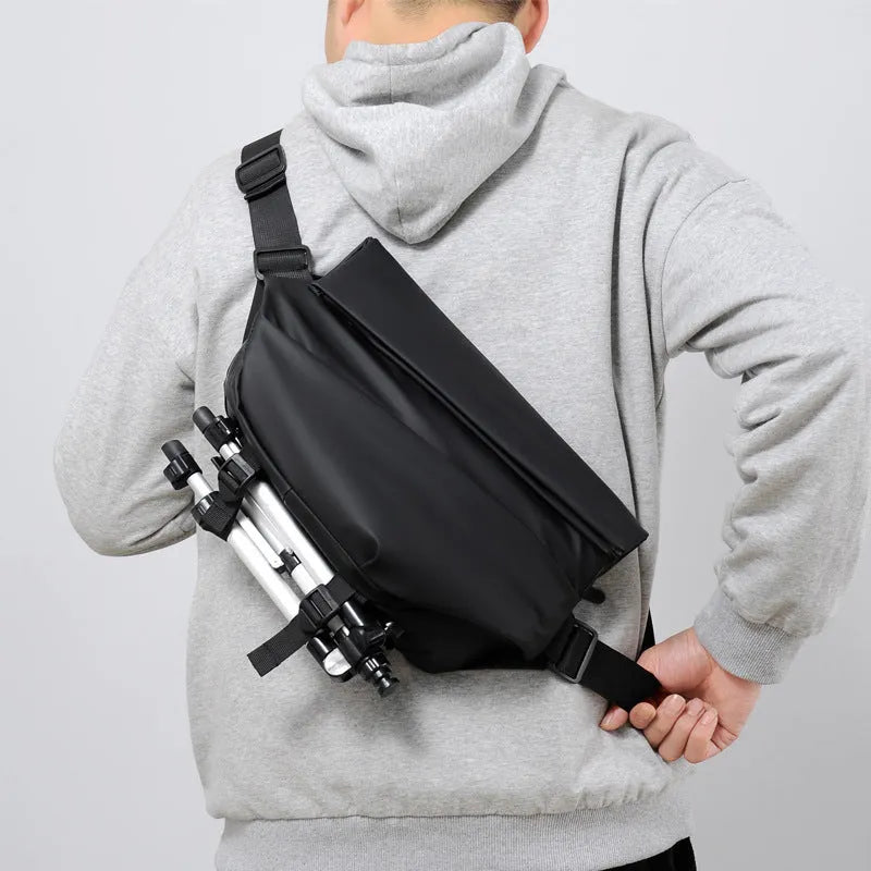 Men's grey PU crossbody chest bag showing zipper opening and adjustable shoulder strap.