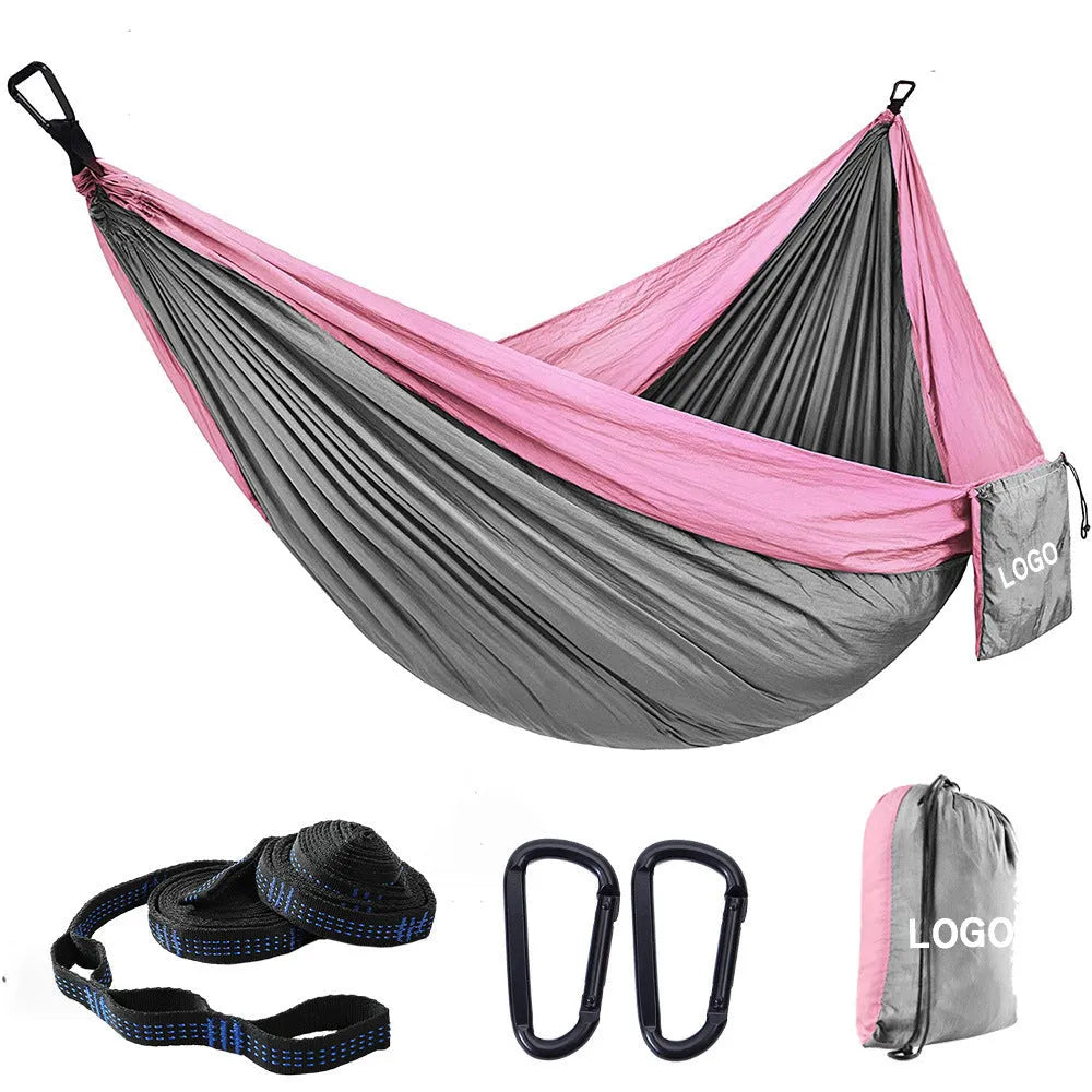 Double camping hammock with ropes and buckles shown in outdoor setting