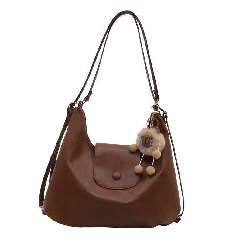 Women's PU leather shoulder bag in horizontal square shape with single strap, showing interior mobile phone compartment