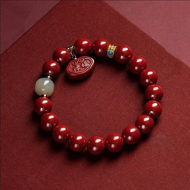 Natural cinnabar bracelet with Emperor sandstone design and Ping An Fu Lu motifs.