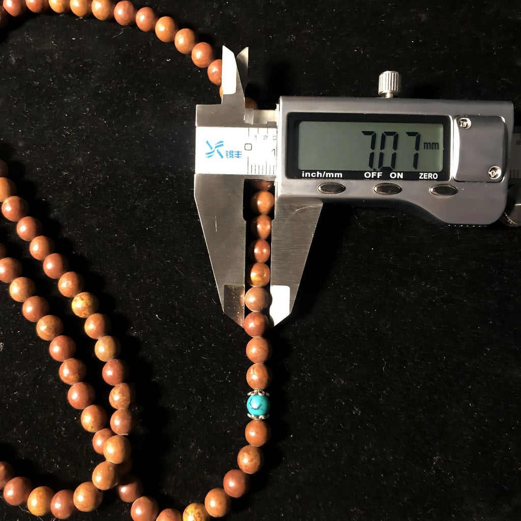 Handmade 108-bead lvzhu stone bracelet with 5-6mm geometric beads on wrist