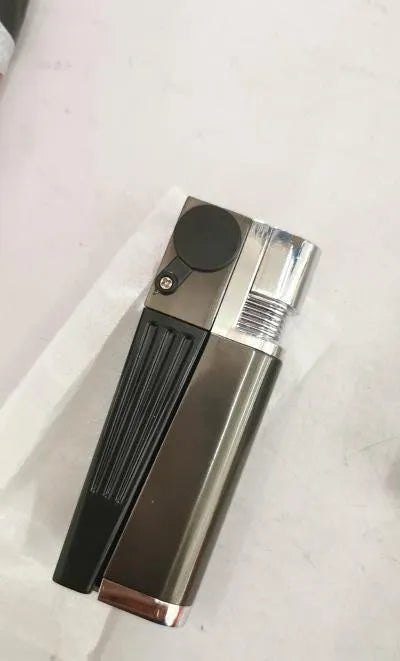 Silver foldable metal pipe lighter shown open, revealing the lighter mechanism and a small stash compartment.