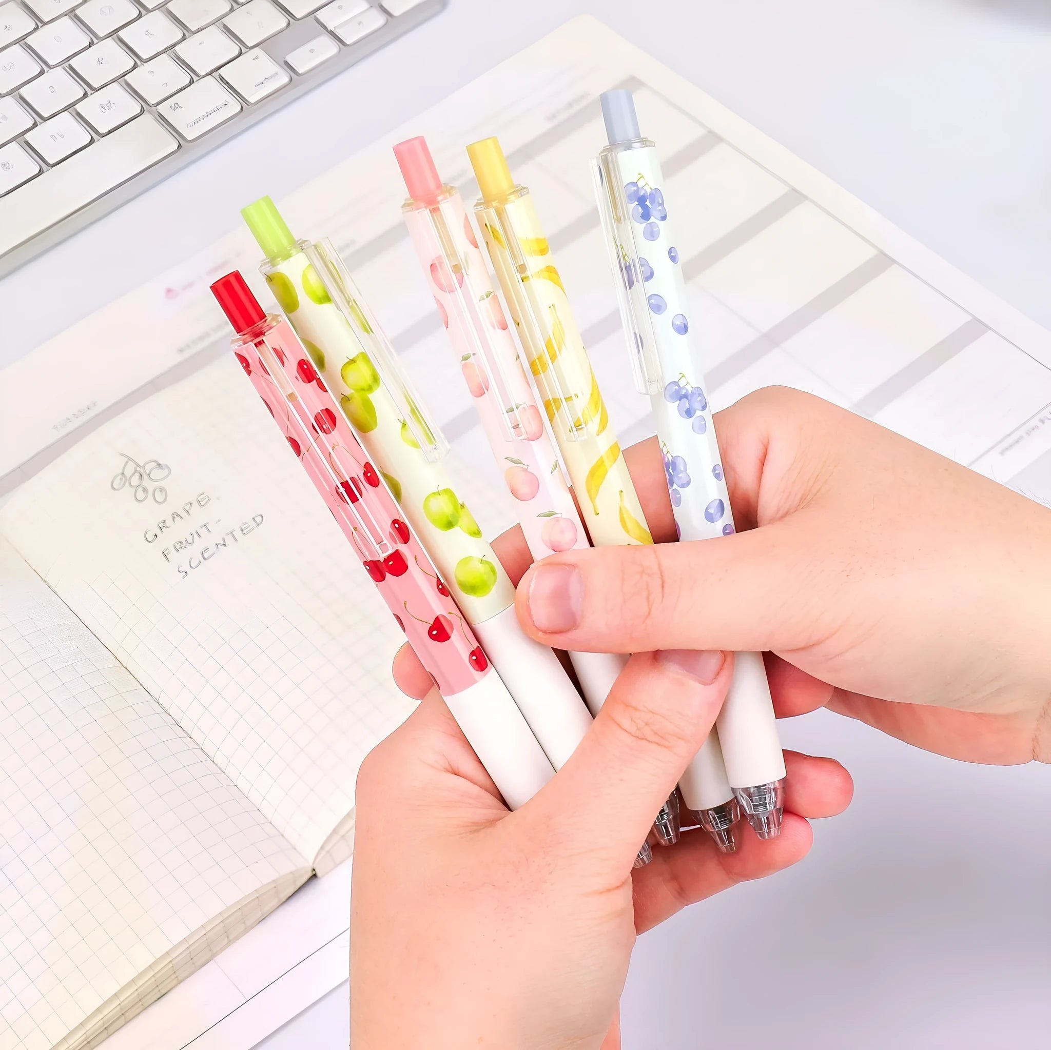 Three scented fruit-designed press-action pens with 0.5mm quick-drying black refills