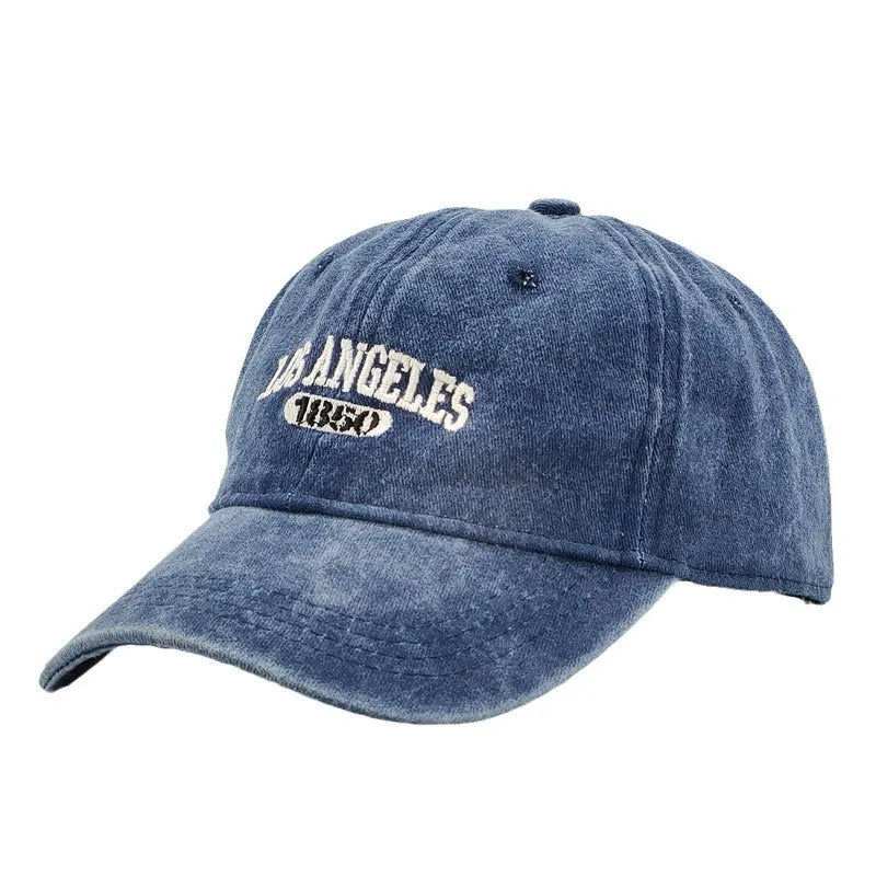 Adult personalised embroidered peaked cap in beige with adjustable strap and distressed lettering.