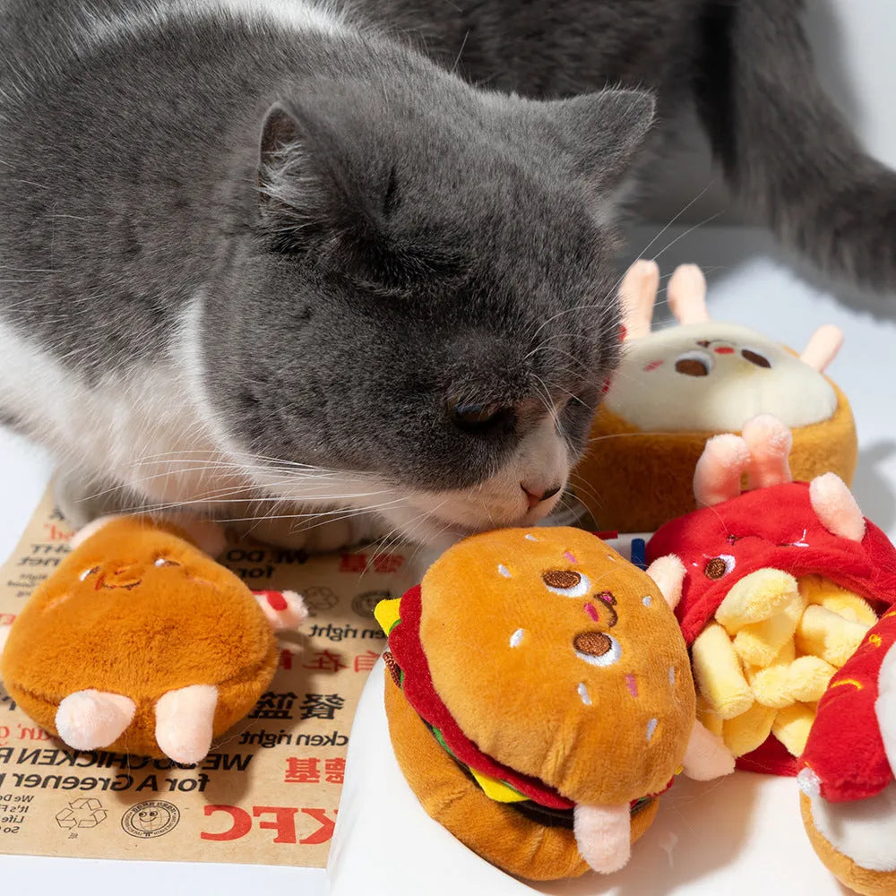 Assorted fast food shaped cat chewing toys including hamburger, chicken leg, bread, fries, and hot dog designs