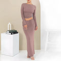 Women's black polyester two-piece suit with waist-exposing top and long skirt
