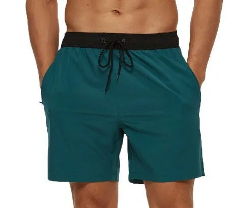 Men's blue fitness shorts with stitched waist headband, drawstring, zipper pocket, and padding for running