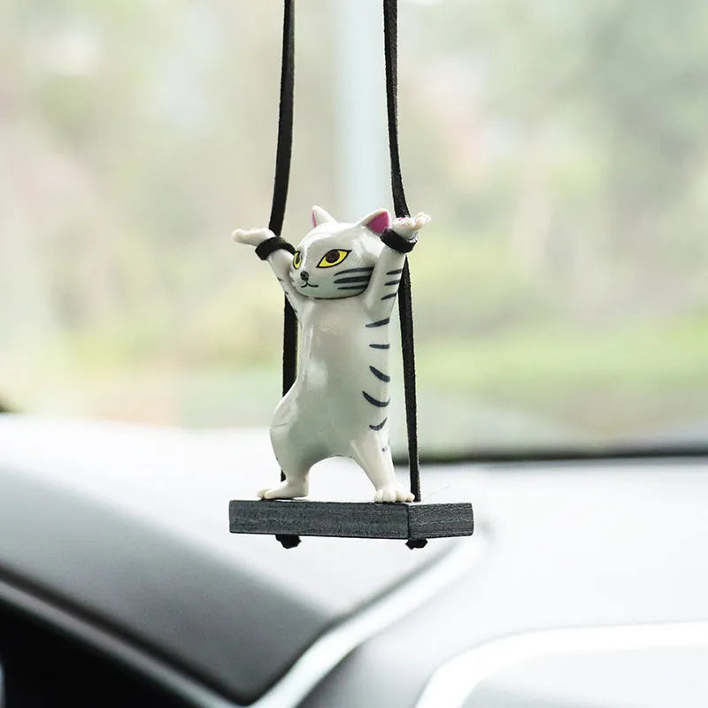 Resin cartoon cat pendant for car interior decoration on adjustable rope.