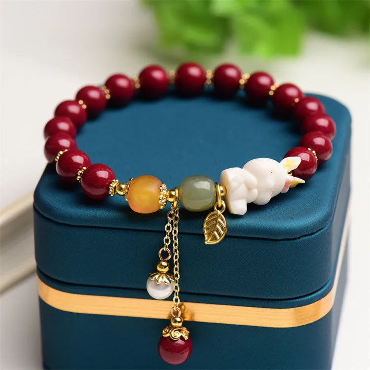 Traditional Chinese cinnabar bracelet with rabbit design, available in 8mm and 10mm bead sizes.
