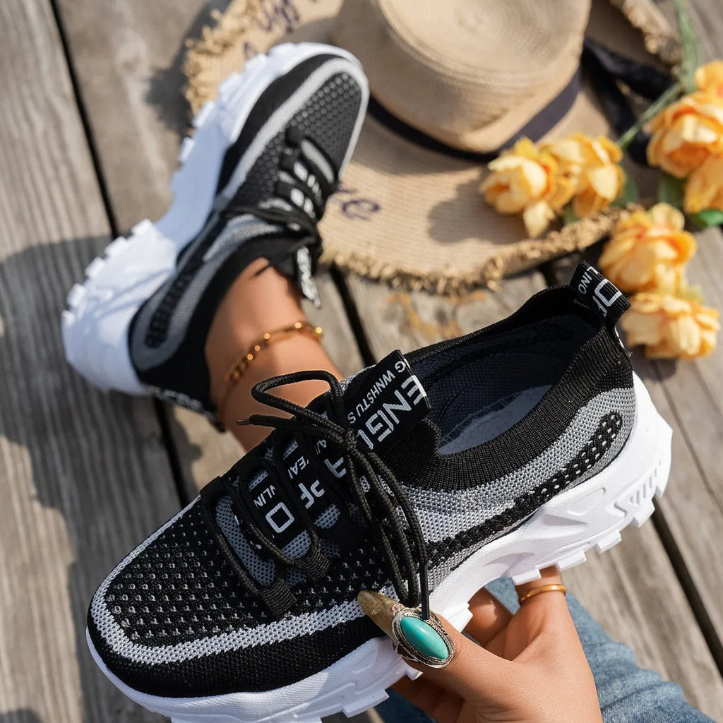Women's Flyknit Mesh sneakers in a neutral colour showing lace-up design and rubber sole.