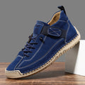 Men's mid-calf black Martin boots with tooling stitching and a flat rubber sole on a white background.