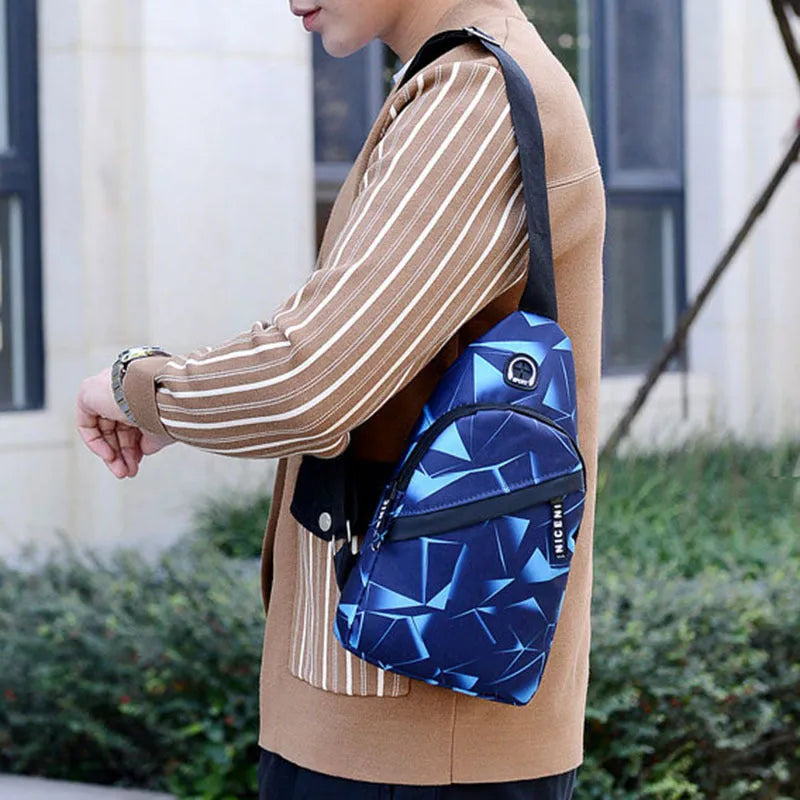 Men's blue Oxford cloth crossbody sling bag with earphone hole design showing zipper opening and letter print detail