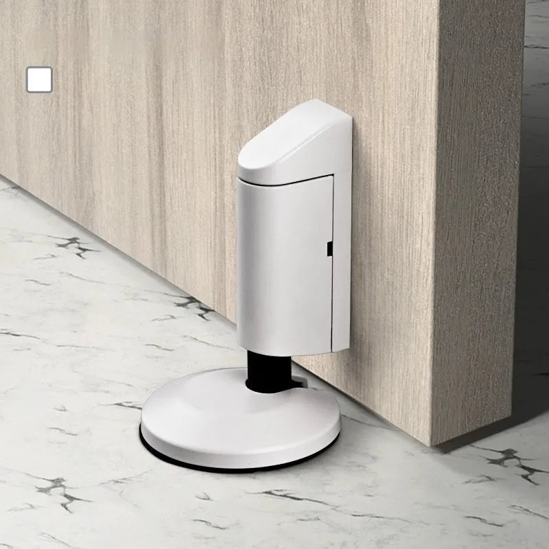 Zinc alloy invisible door stopper in brushed nickel finish on a wooden floor