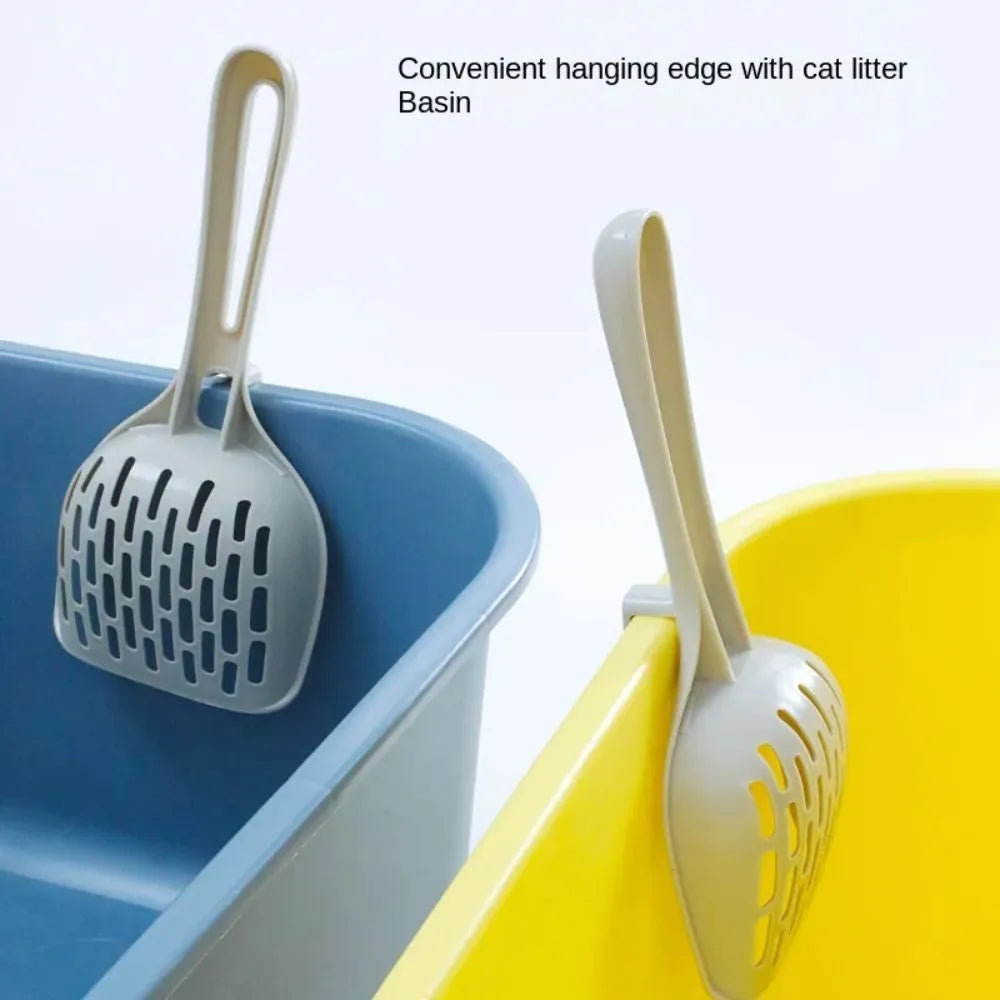 Grey plastic cat litter scoop resting on its matching plastic base stand.