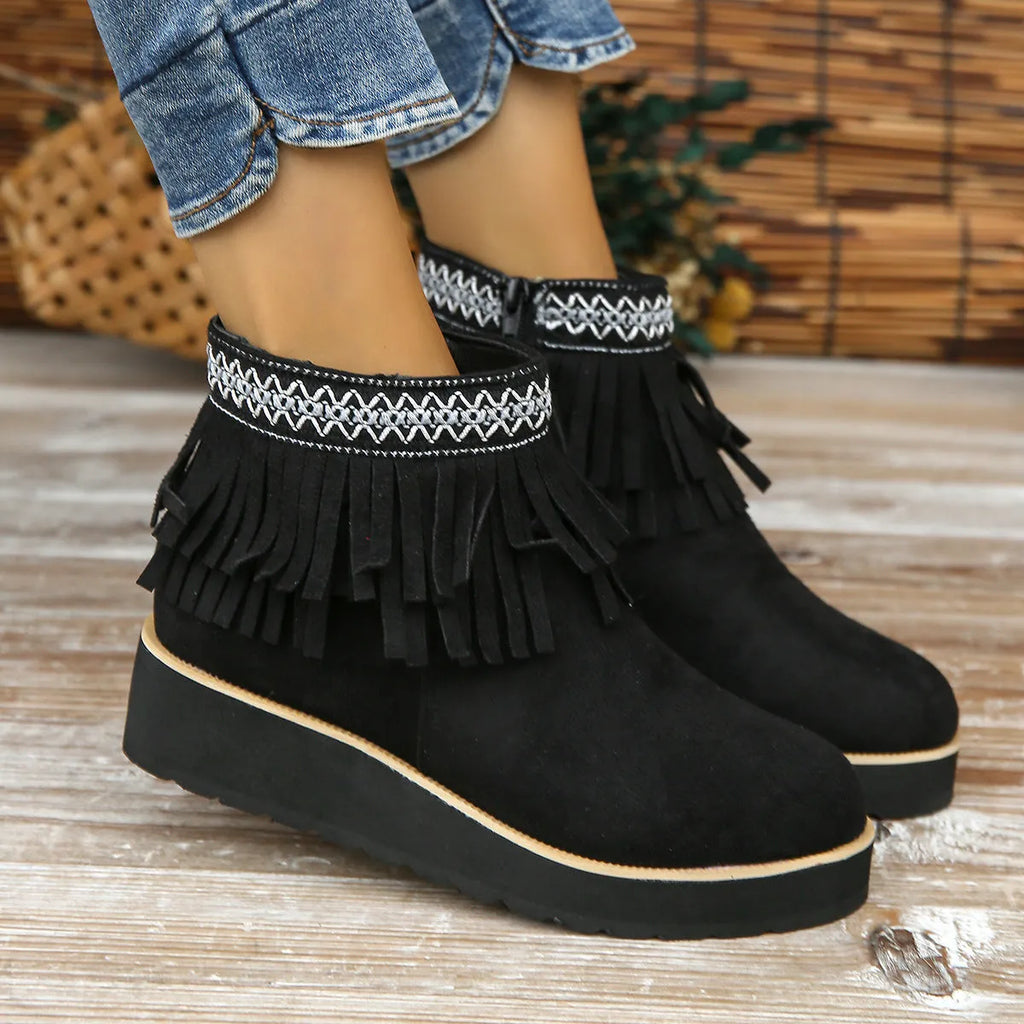 Women's dark brown suede ankle boot with wedge heel, side zipper, and decorative tassel.