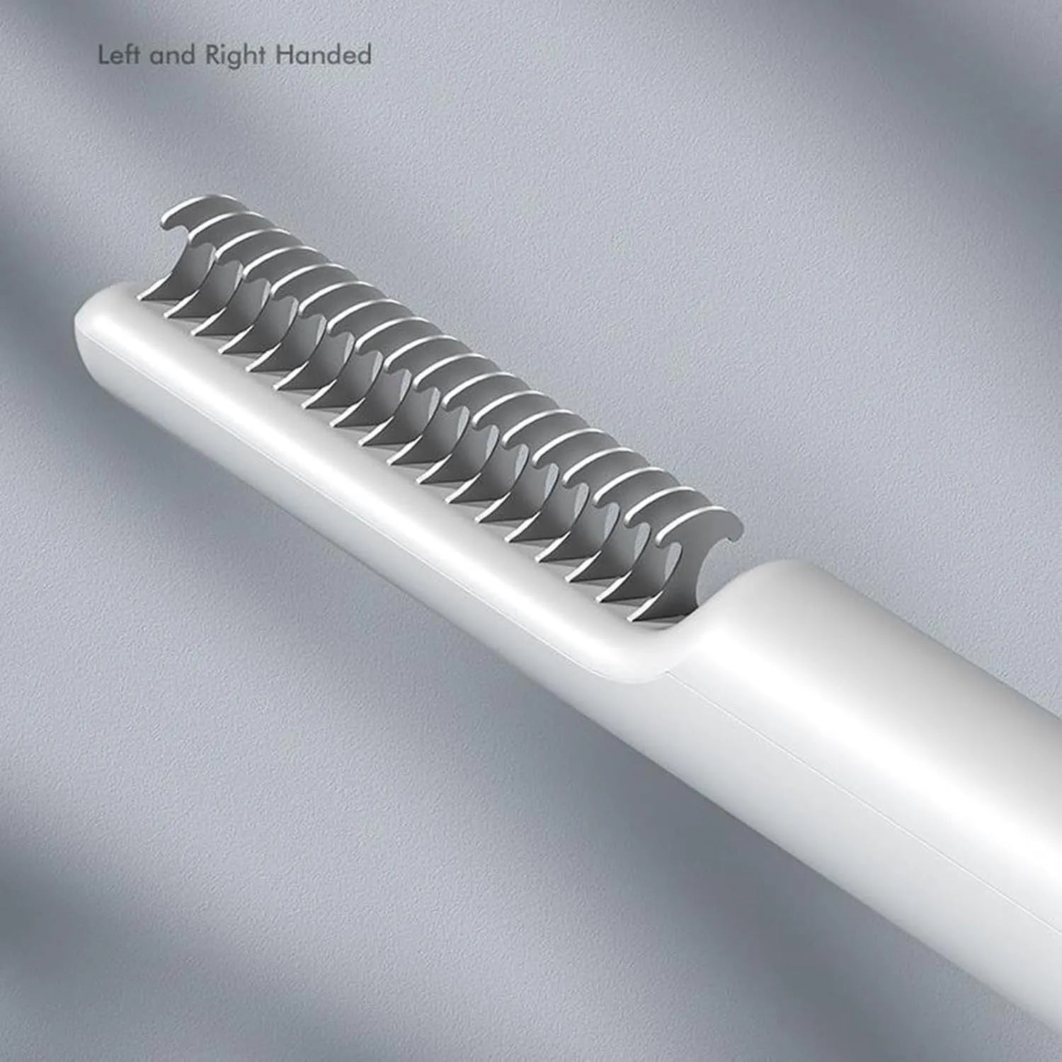Stainless steel dog dematting comb with ergonomic handle on a white background