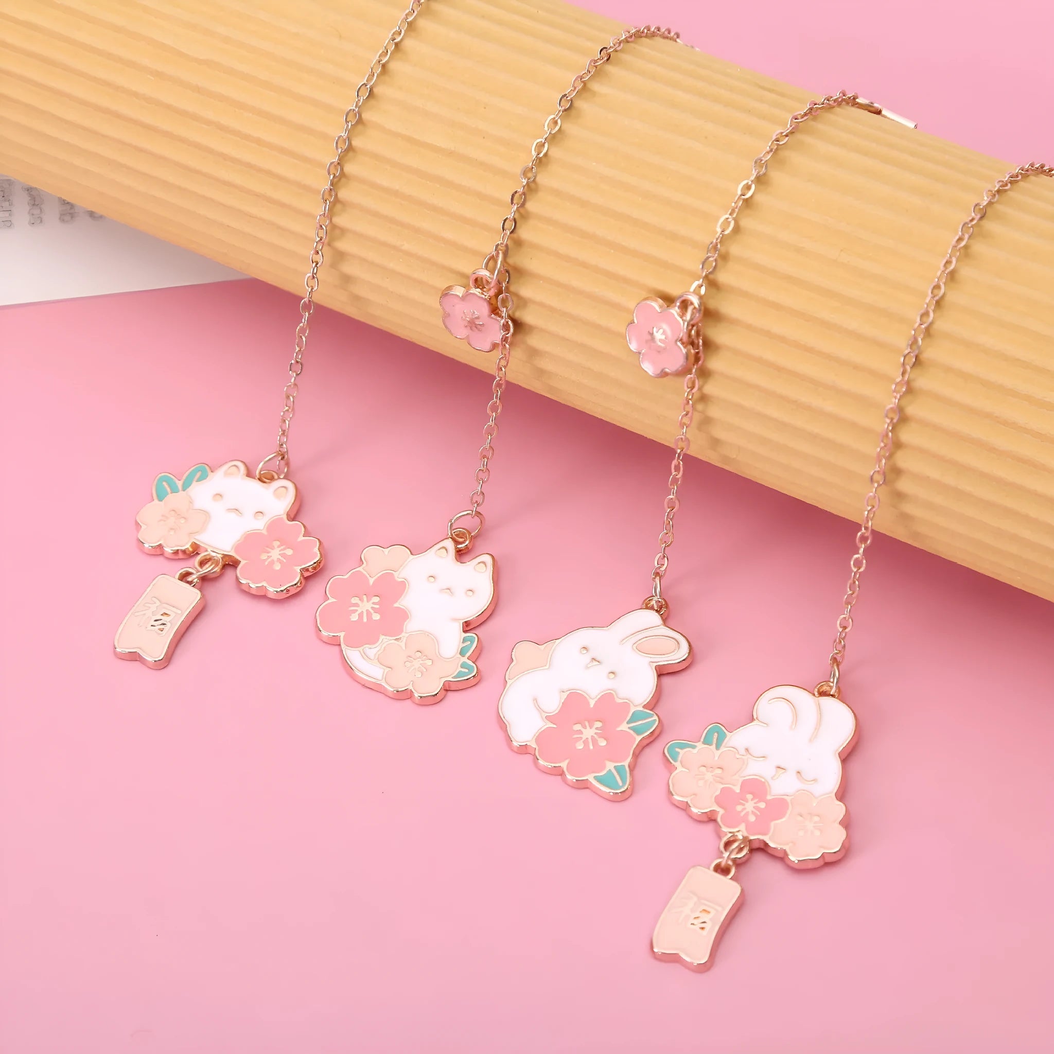 Creative cartoon metal pendant bookmark featuring cherry blossom cat and rabbit designs.