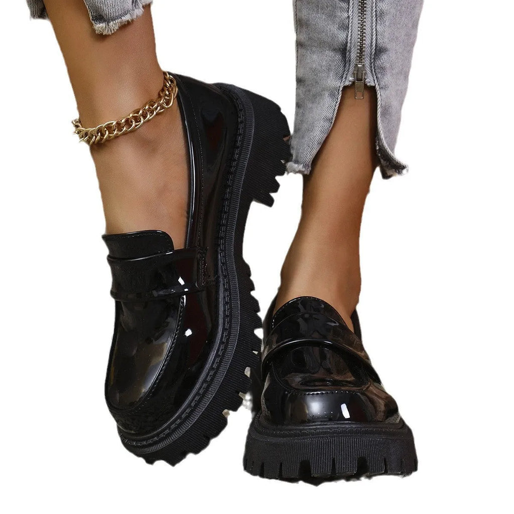 Plus size women's black slip-on loafers with a chunky mid-heel and thick rubber sole.