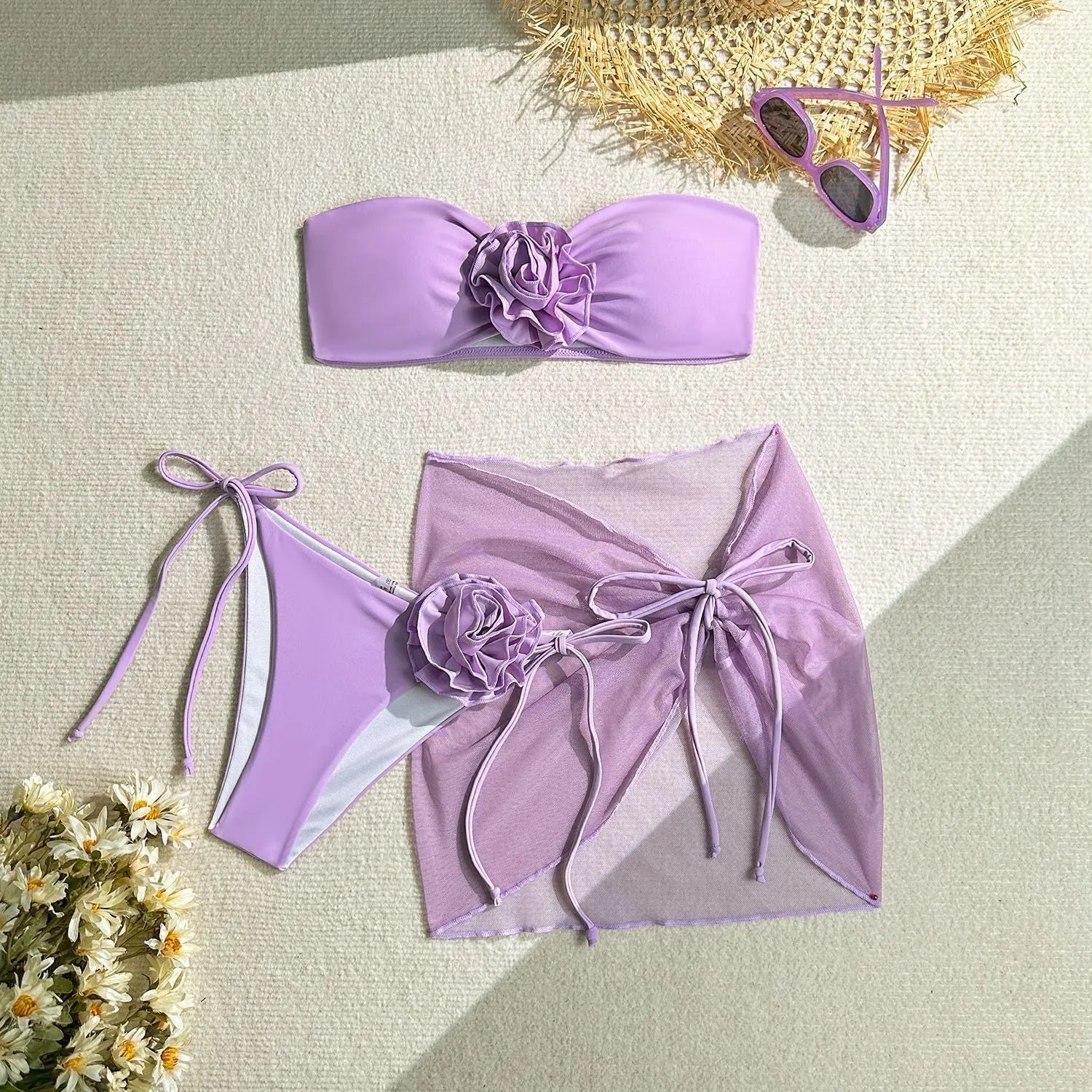 Women's pink tube top swimsuit with 3D flower detail, matching pants, and skirt laid flat.