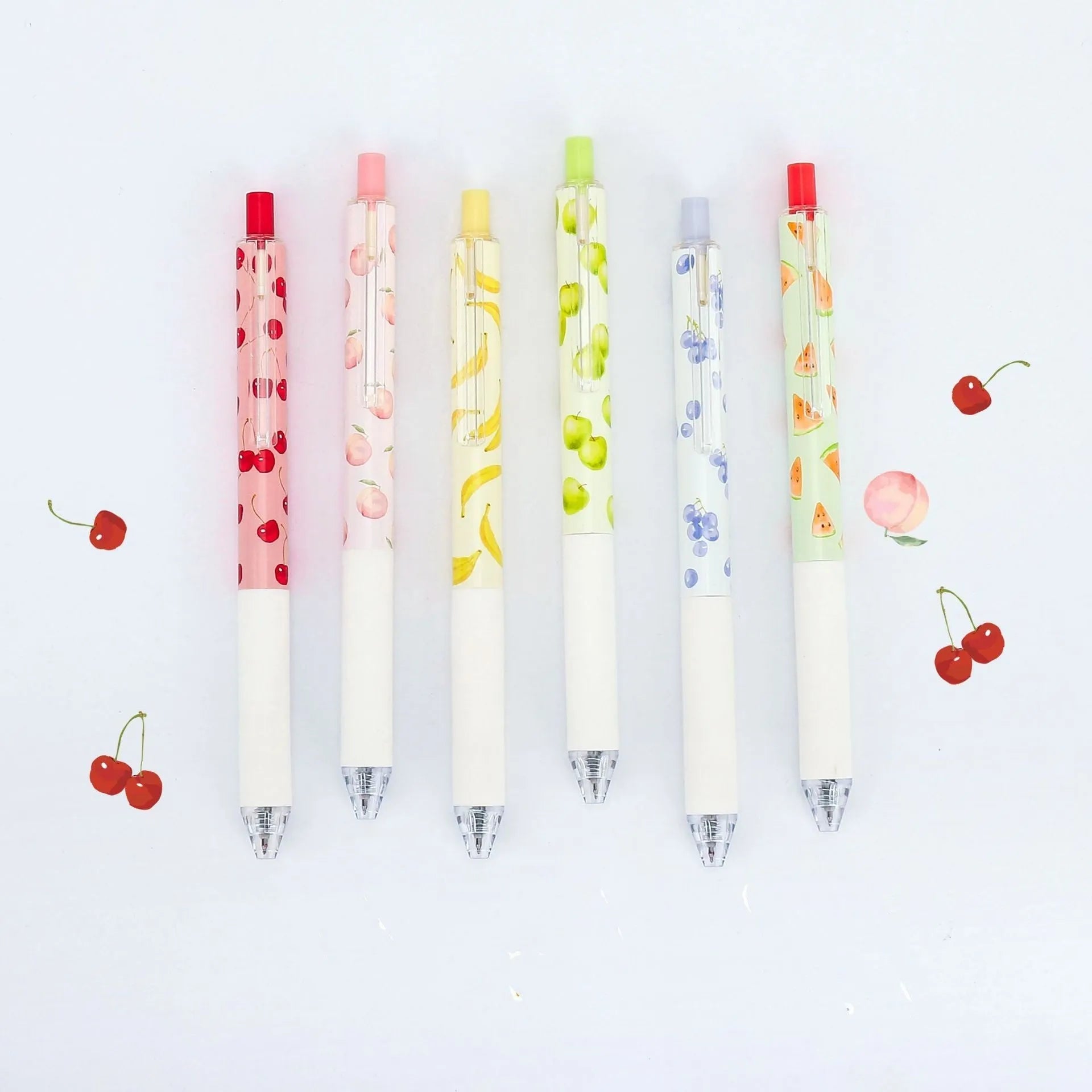 Three scented fruit-designed press-action pens with 0.5mm quick-drying black refills