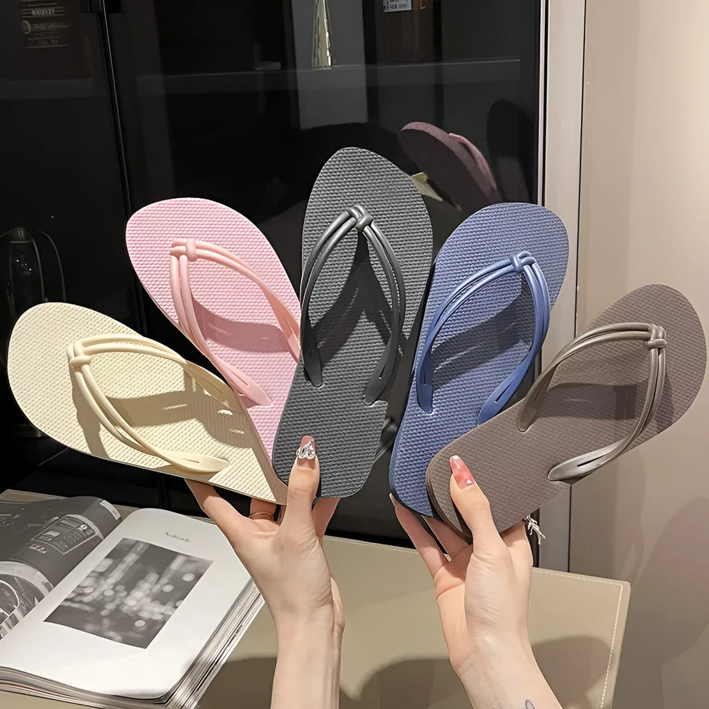 Women's PVC flip flops with toe-covering style and non-slip sole in multiple colours.
