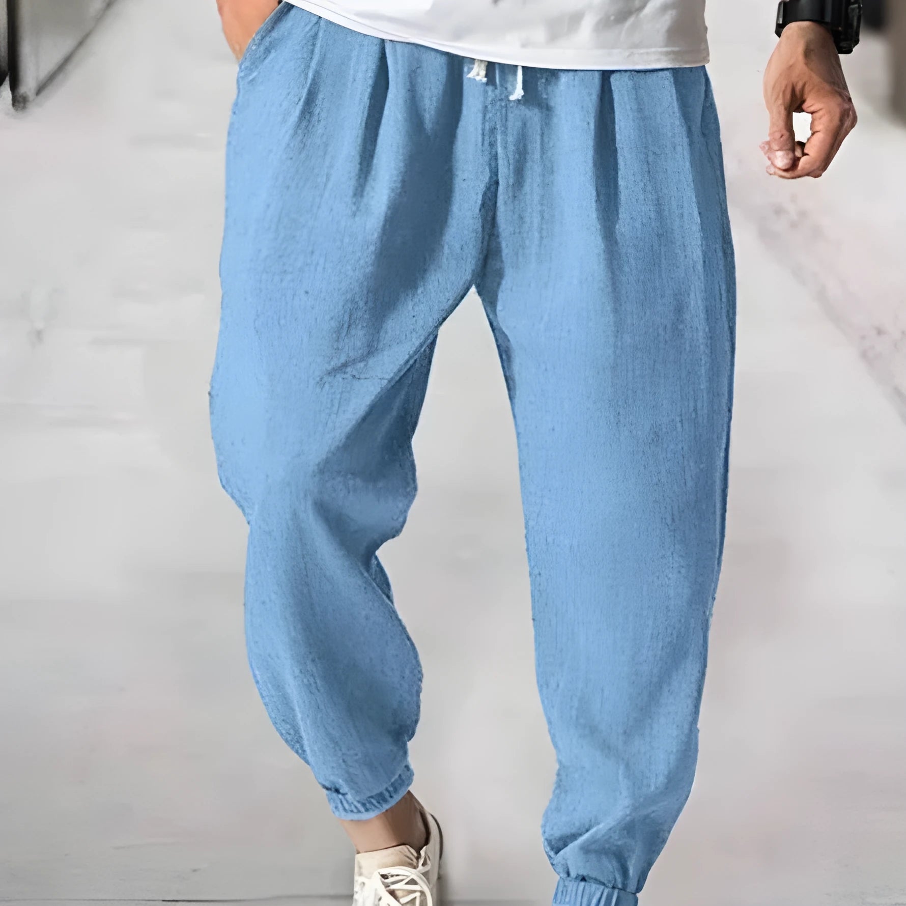 Men's casual cotton trousers with banded ankles in light green colour showing loose fit summer style