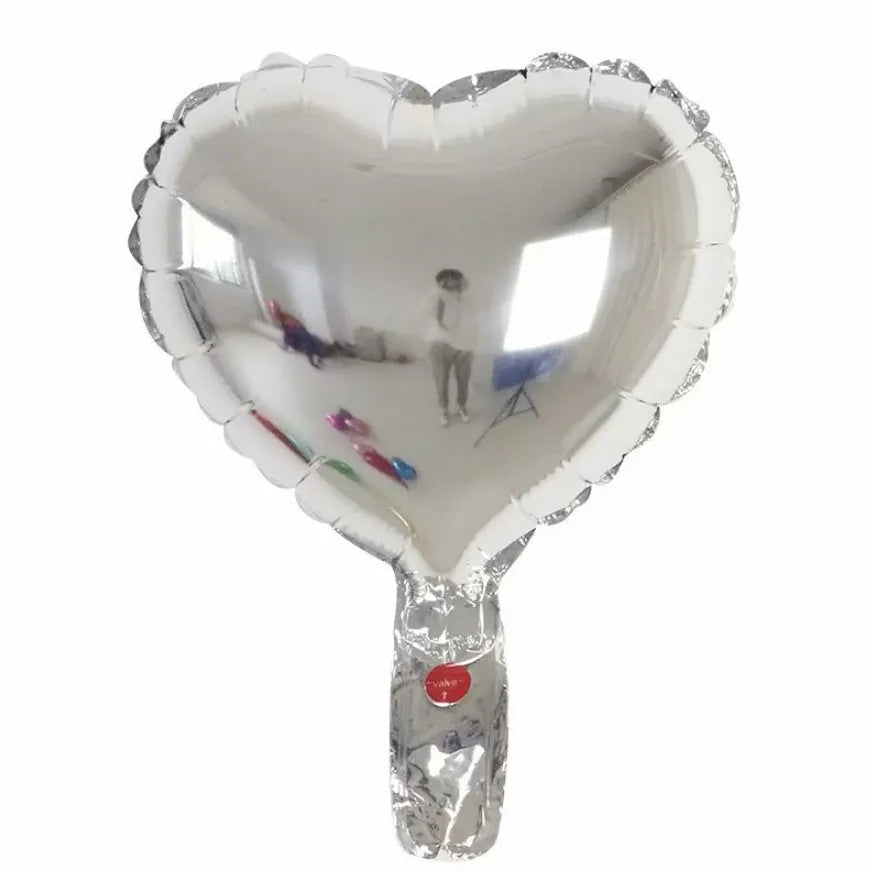 Five peach heart-shaped aluminium balloons in sparkling metallic colours: red, blue, rose, and silver.