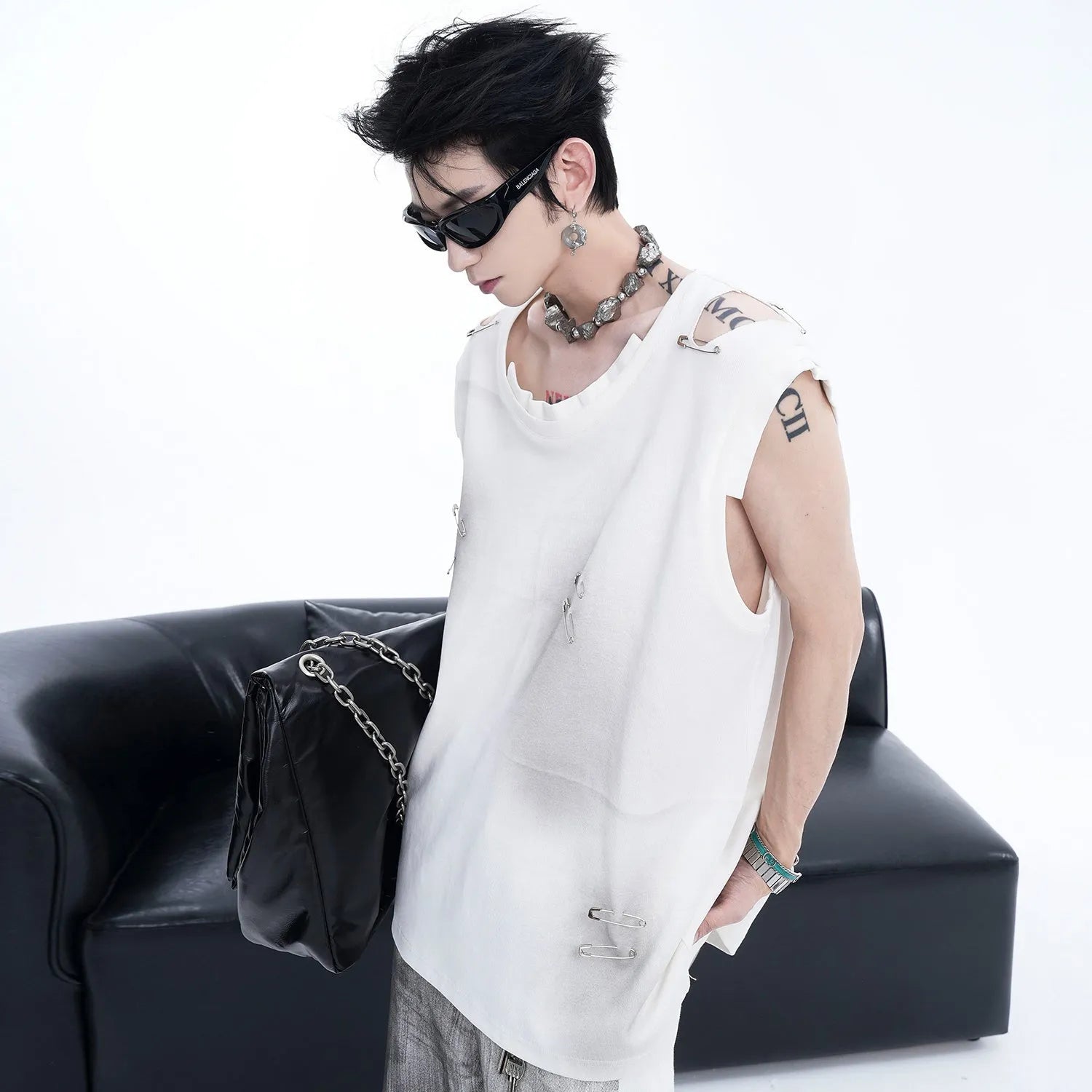 Men's black sleeveless vest t-shirt with irregular rip cut detail and round neck collar.