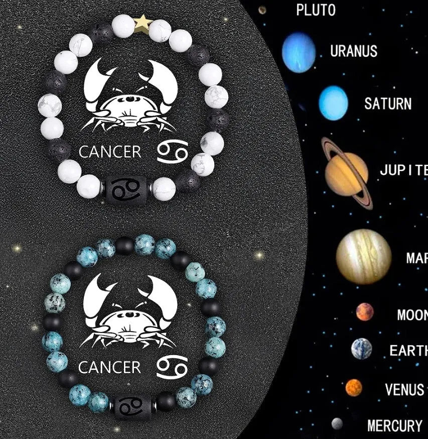 Two natural stone beaded zodiac bracelets with adjustable strings on wooden surface