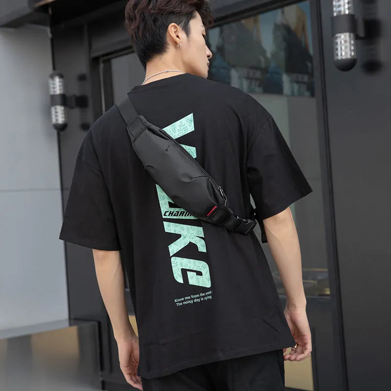 Men's black Oxford cloth crossbody waist pack showing interior phone and ID pockets