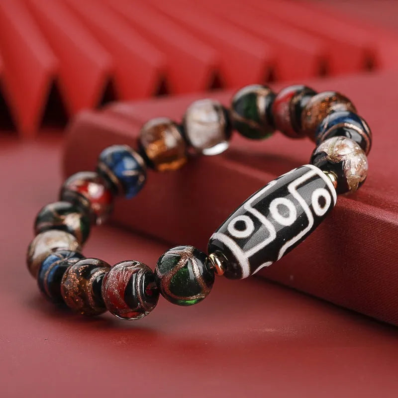 Close-up of a coloured glaze bracelet with traditional Chinese snake design and multi-coloured beads.