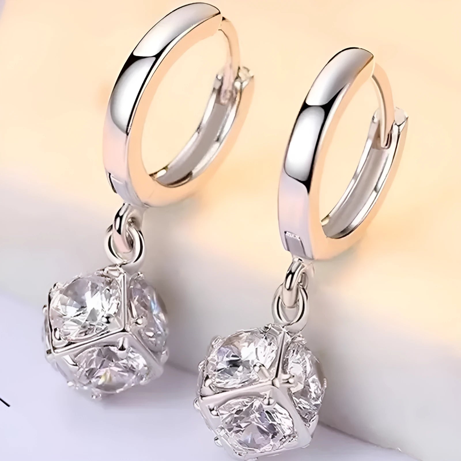 A pair of women's geometric copper earrings with a rose design and small zircon stone accents.