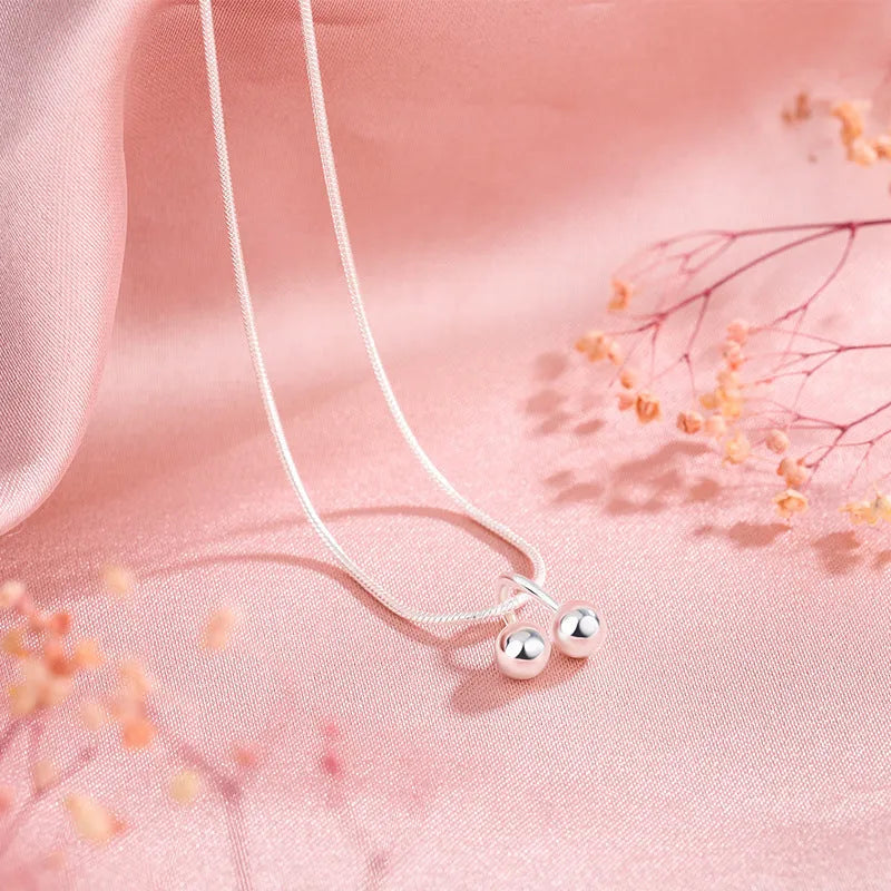 Silver cherry necklace for women with adjustable snake bone chain and Korean-style fruit pendant.