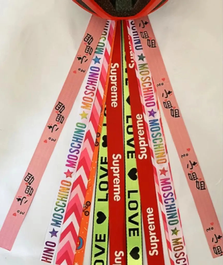 A colourful helmet streamer accessory for children's sports helmets and doll decoration.