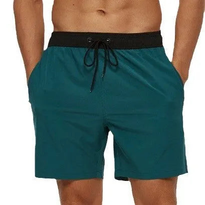 Men's blue fitness shorts with stitched waist headband, drawstring, zipper pocket, and padding for running